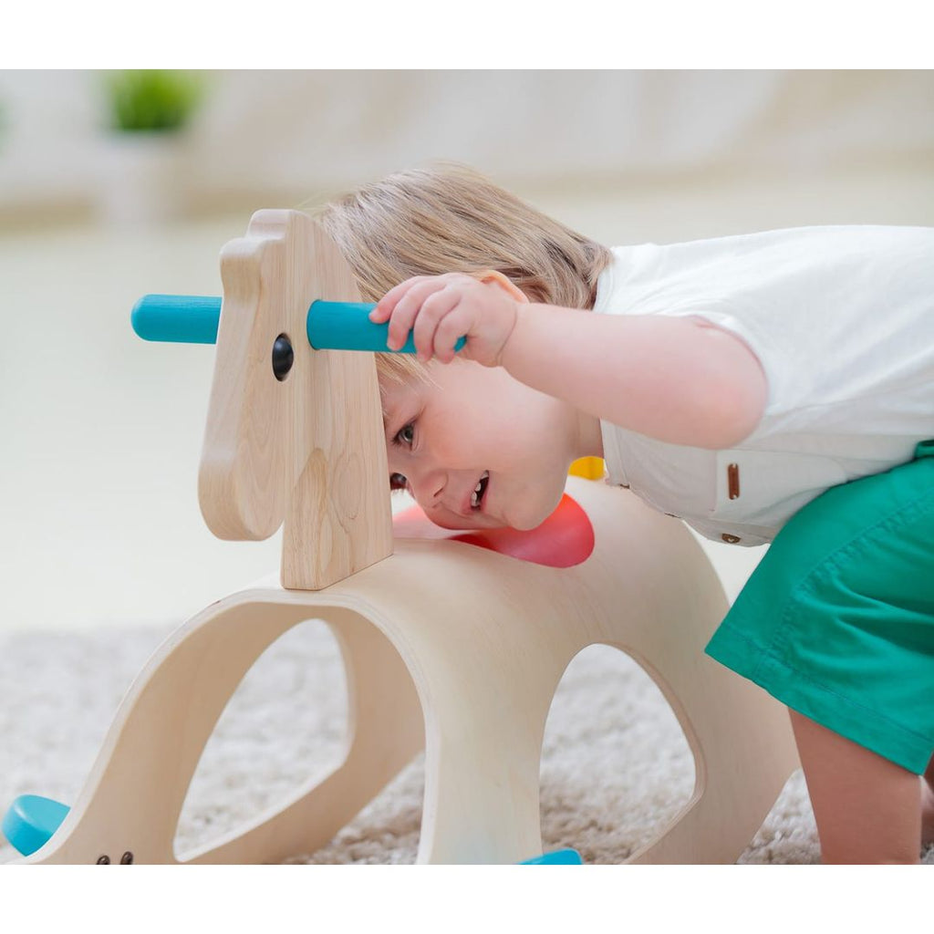 Kid playing PlanToys Palomino