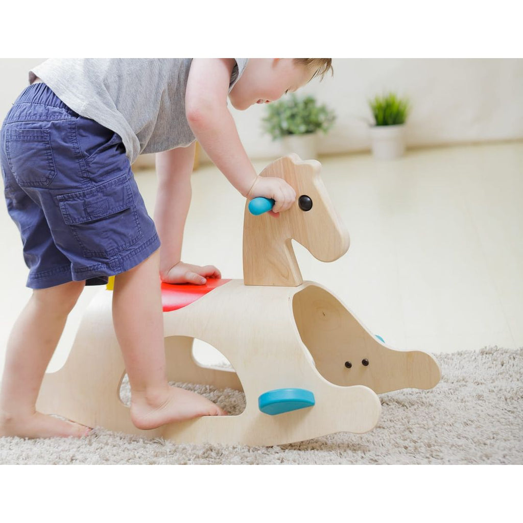 Kid playing PlanToys Palomino