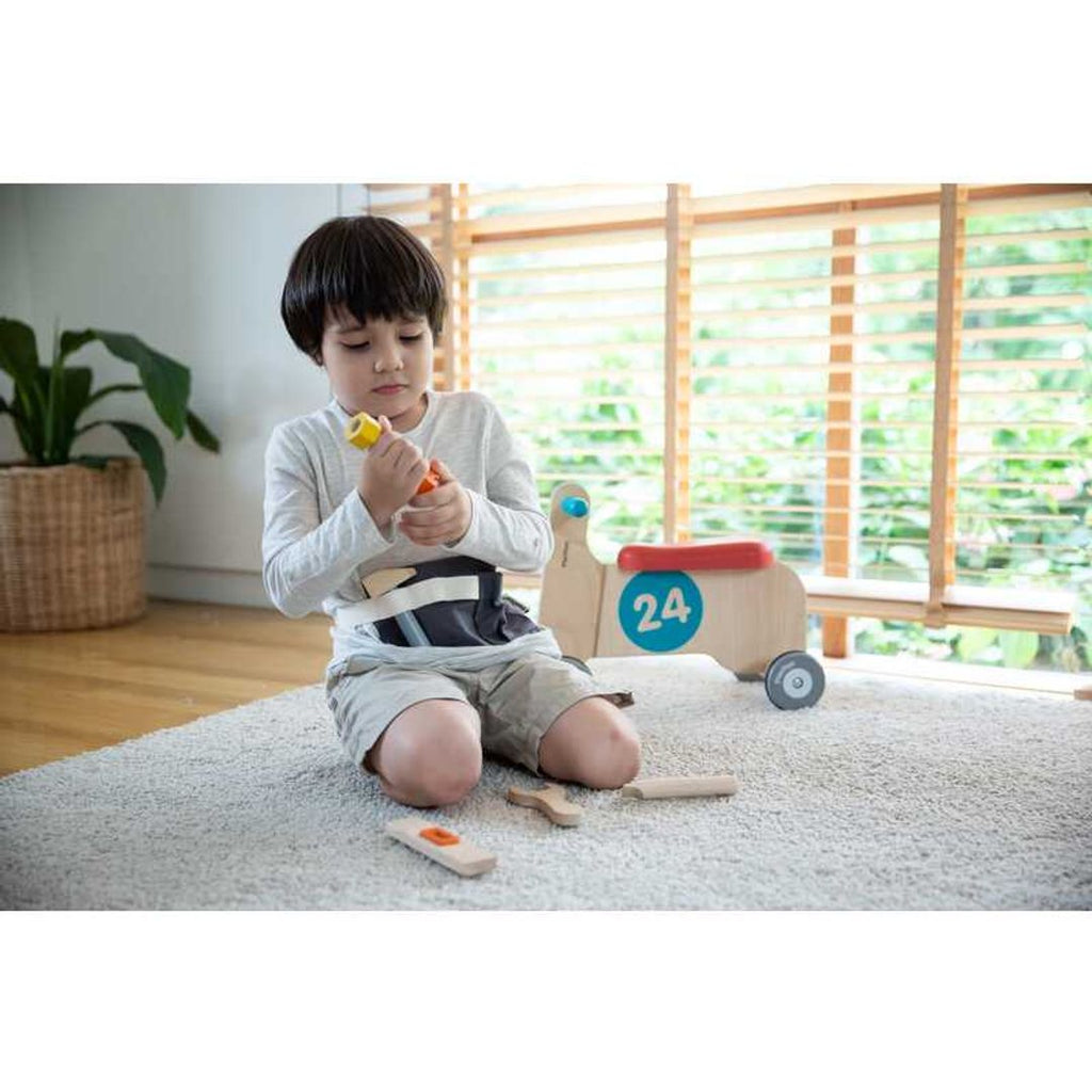 Kid playing PlanToys Tool Belt