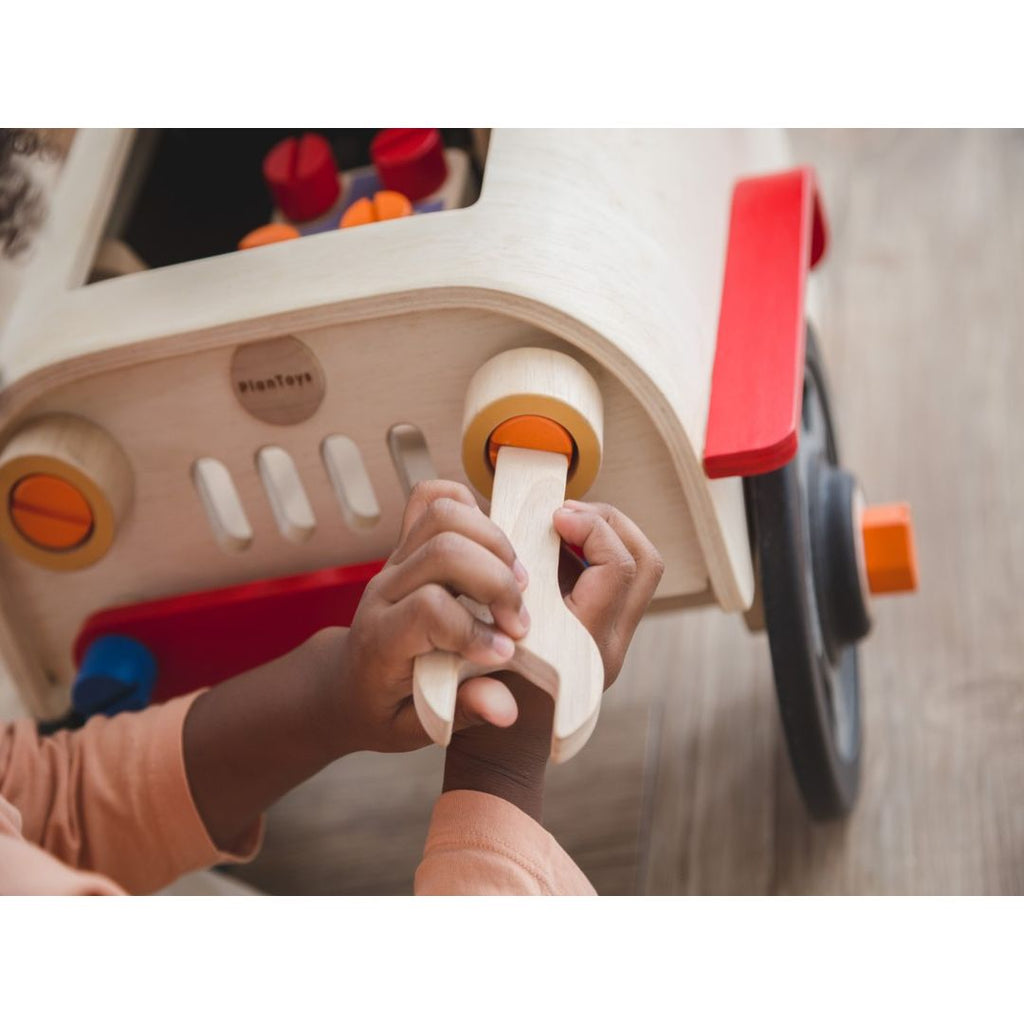 Kid playing PlanToys Motor Mechanic