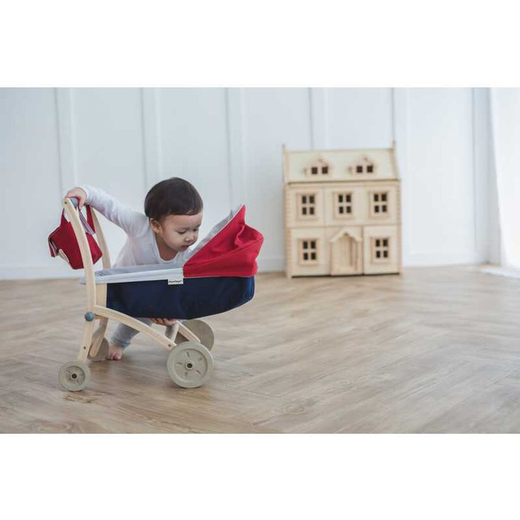 Kid playing PlanToys Doll Stroller