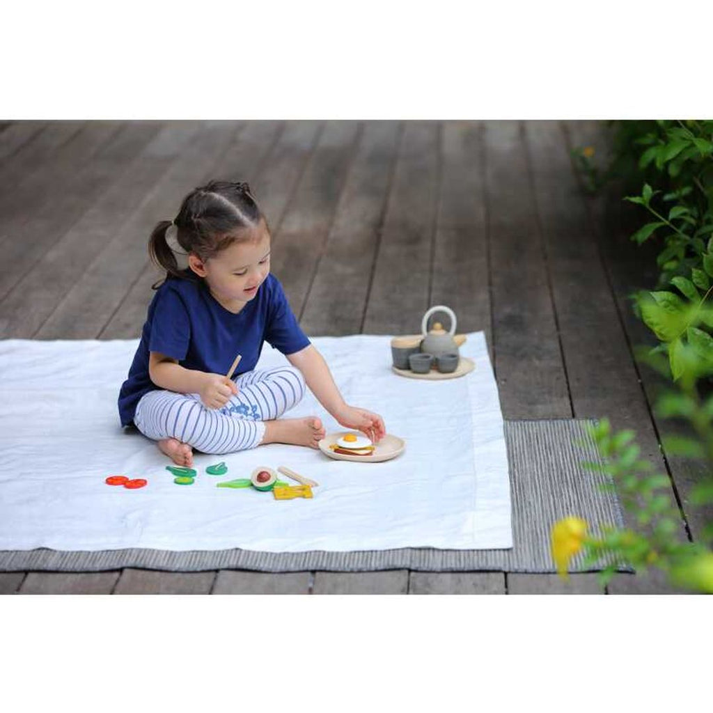 Kid playing PlanToys Breakfast Set