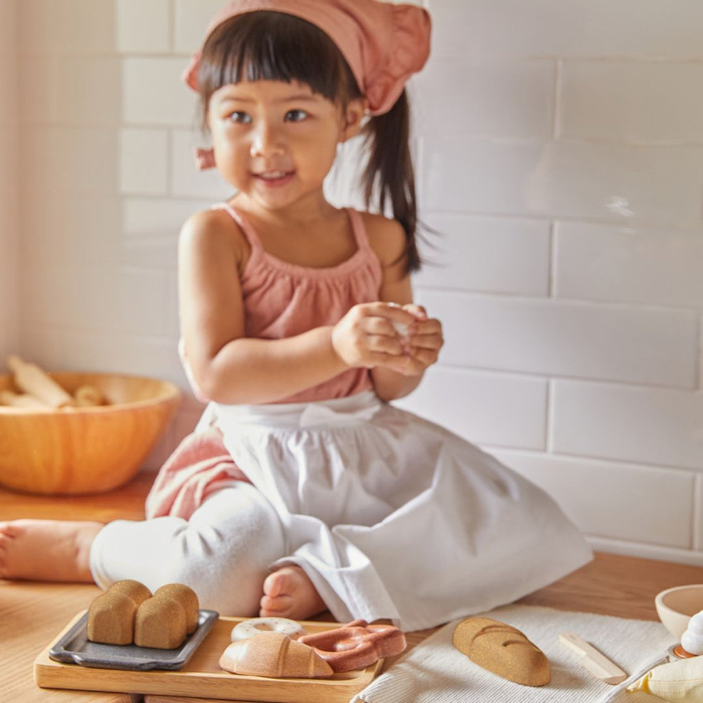 Kid playing PlanToys Bread Set