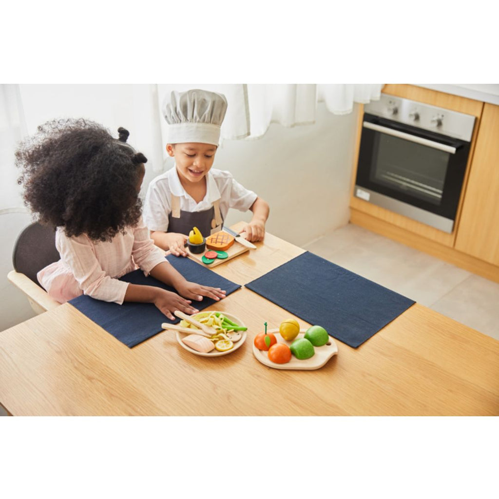 Kid playing PlanToys Steak Set