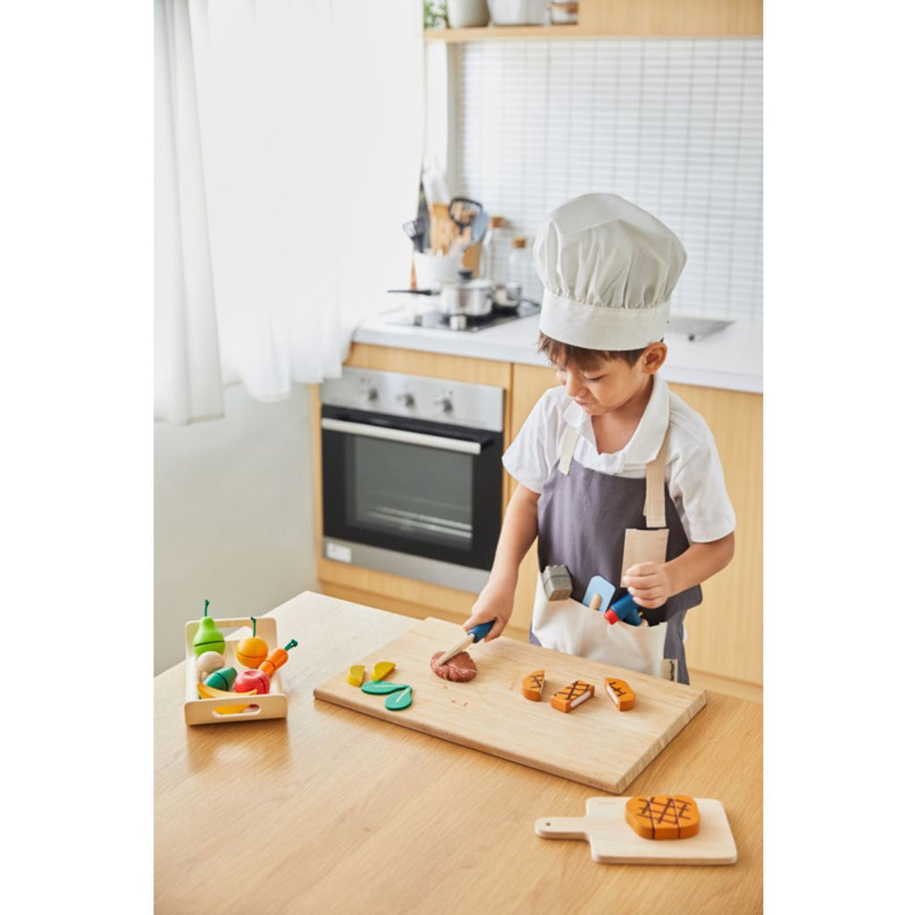 Kid playing PlanToys Chef Set