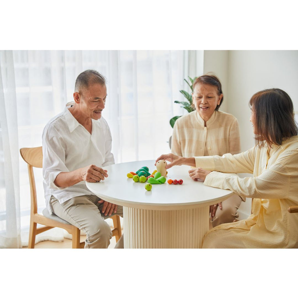 Elderly playing PlanToys Balancing Cactus