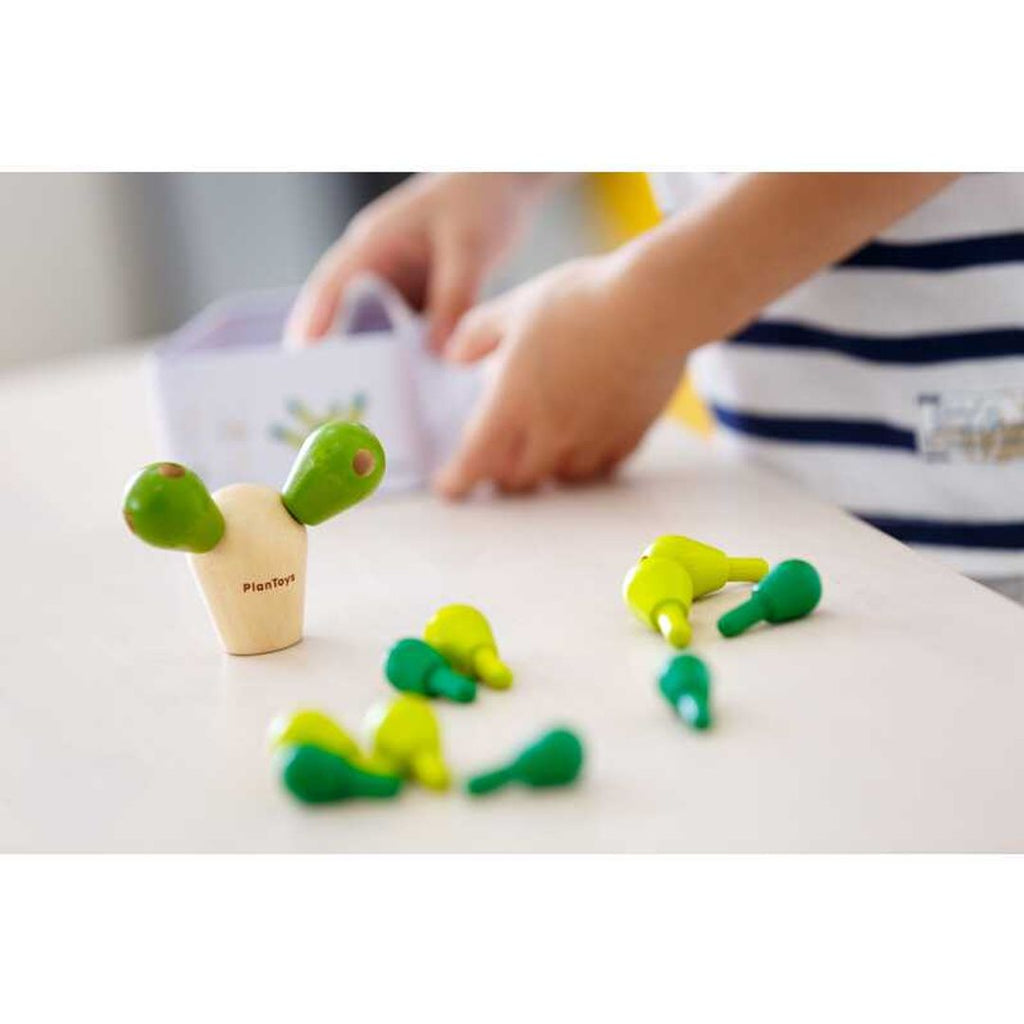 Kid playing PlanToys Balancing Cactus