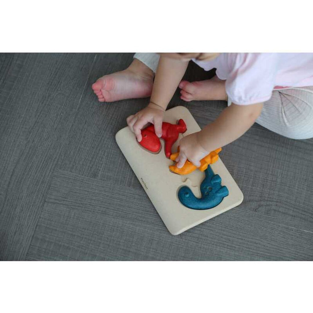 Kid playing PlanToys Dino Puzzle