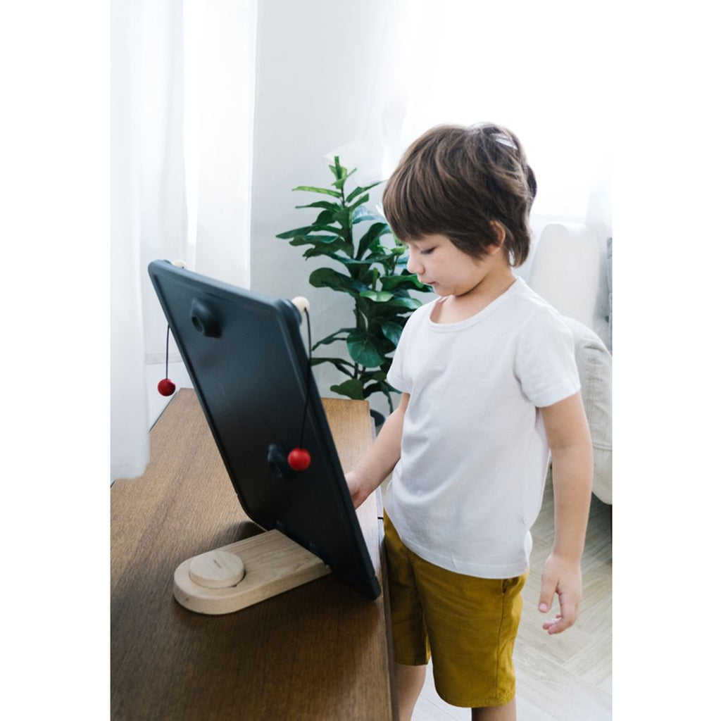 Kid playing PlanToys Wall Ball Game