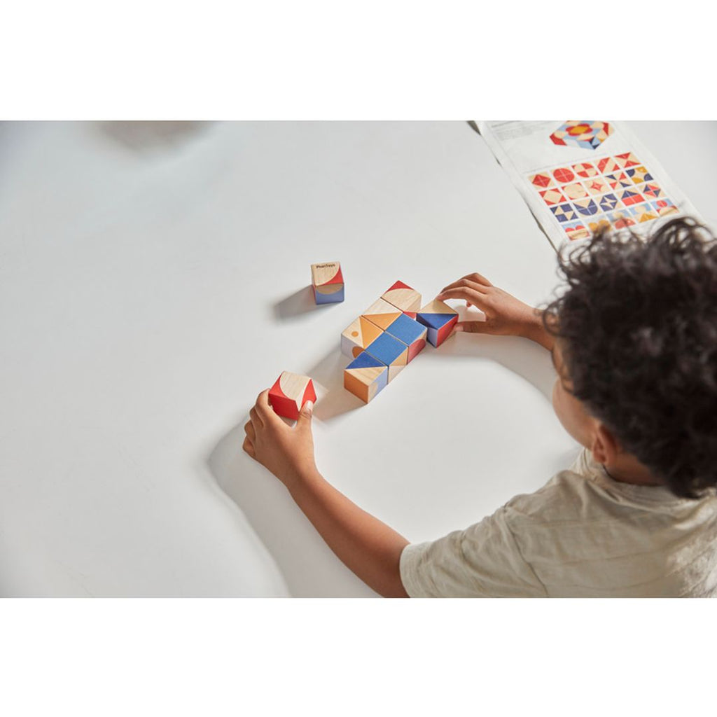 Kid playing PlanToys Geo Pattern Cubes