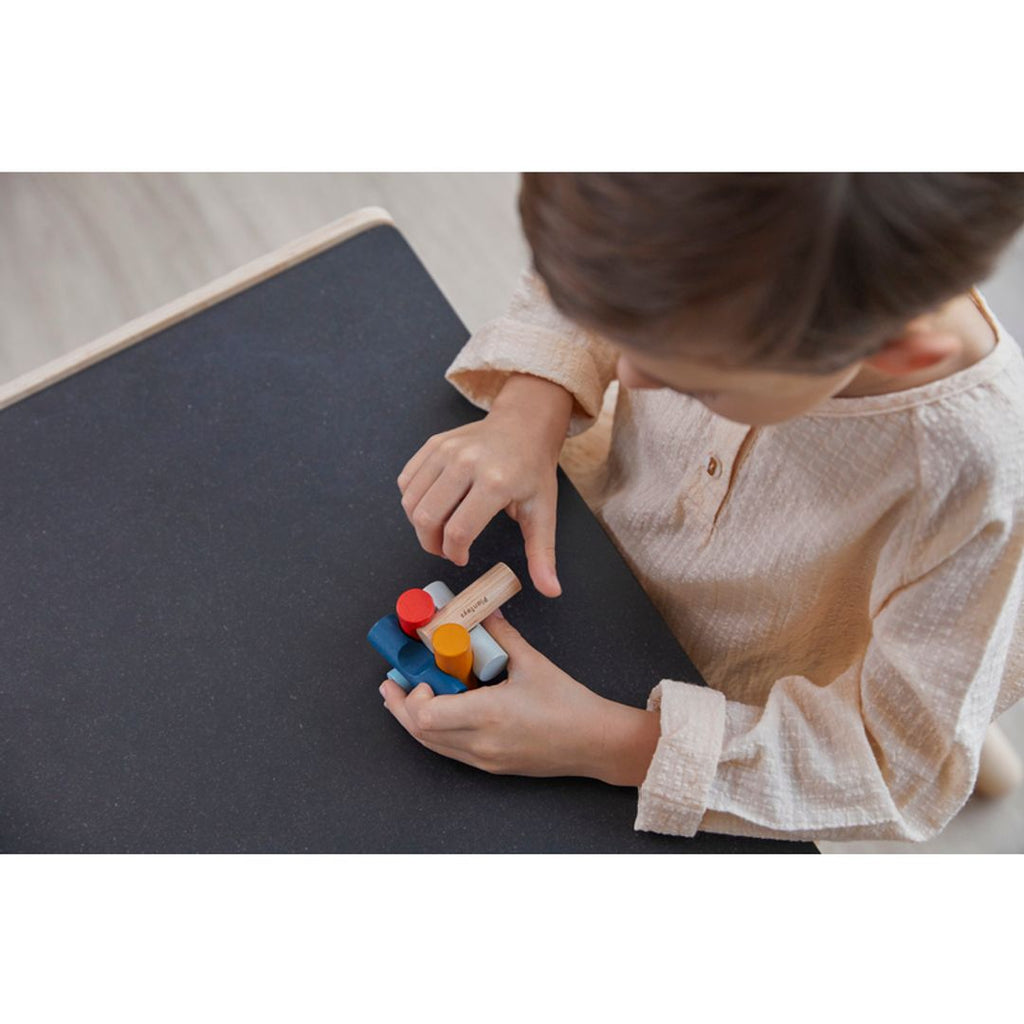 Kid playing PlanToys Log Puzzle