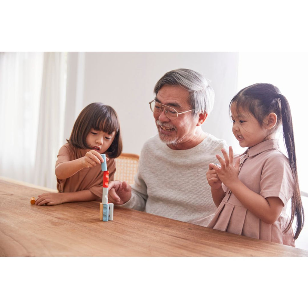 Kid playing PlanToys Log Puzzle