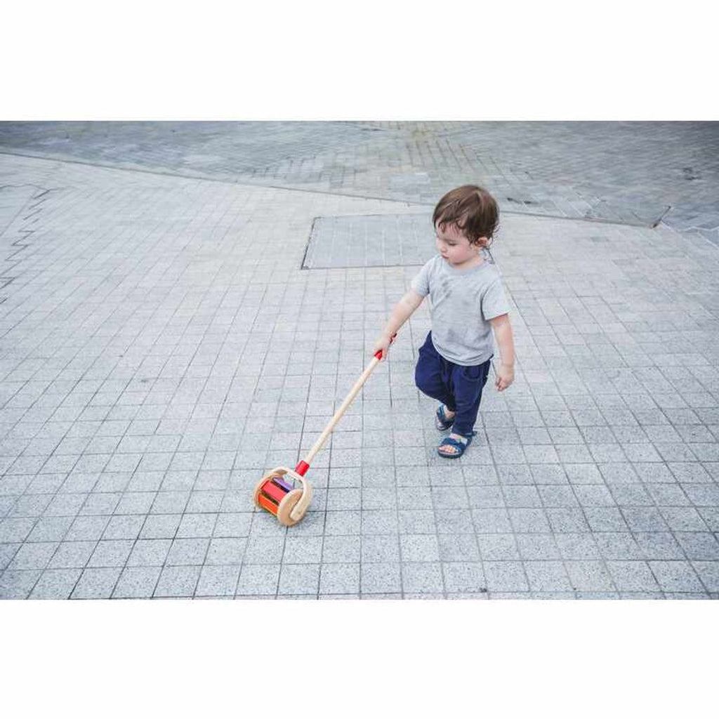 Kid playing PlanToys Walk N Roll