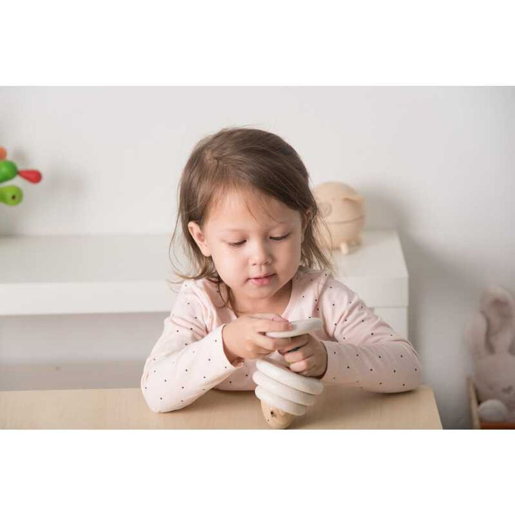 Kid playing PlanToys Lacing Sheep