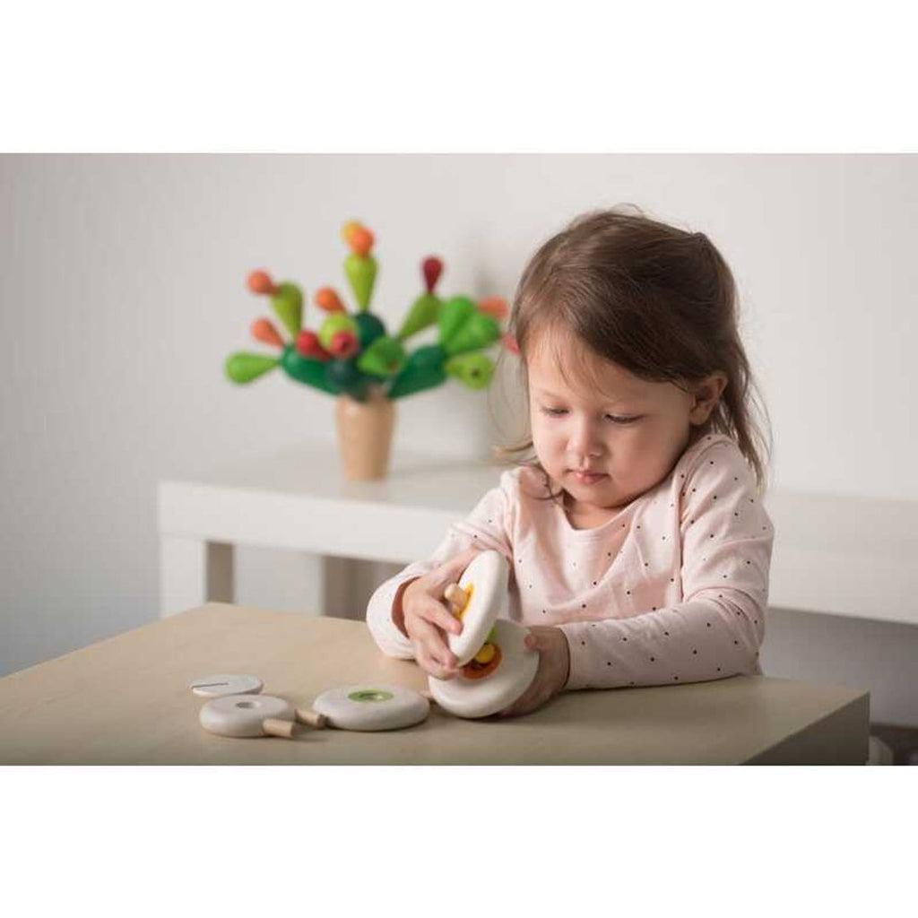 Kid playing PlanToys Lacing Sheep