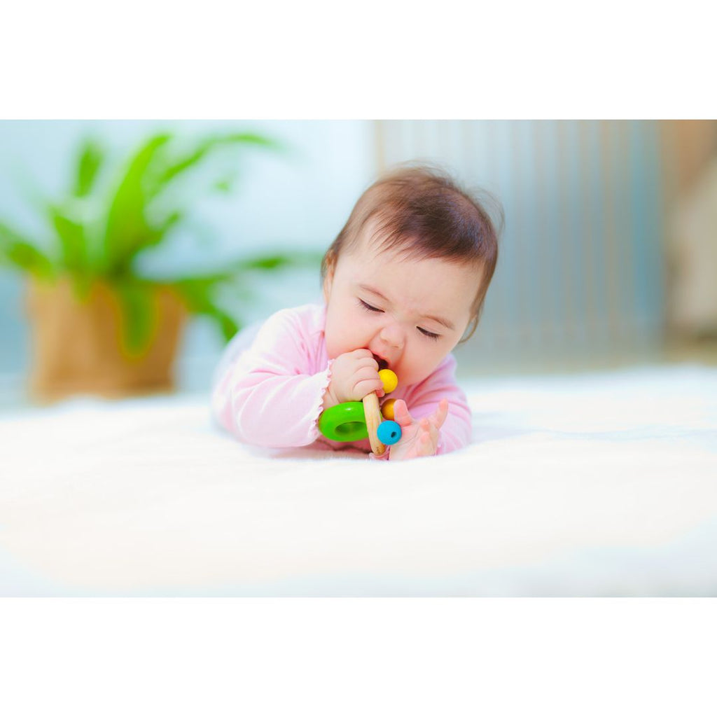 Kid playing PlanToys Bell Rattle