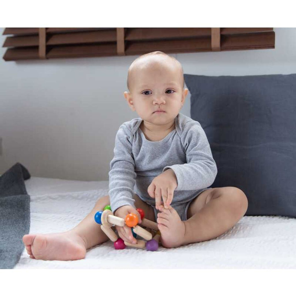 Kid playing PlanToys Square Clutching Toy