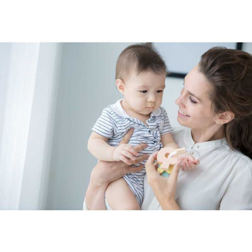 Kid playing PlanToys Key Rattle