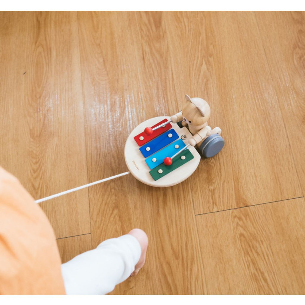 Kid playing PlanToys Pull Along Musical Bear