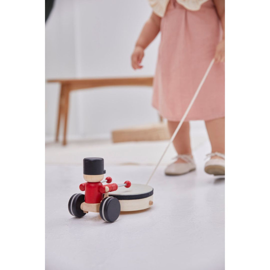 Kid playing PlanToys Pull Along Drummer