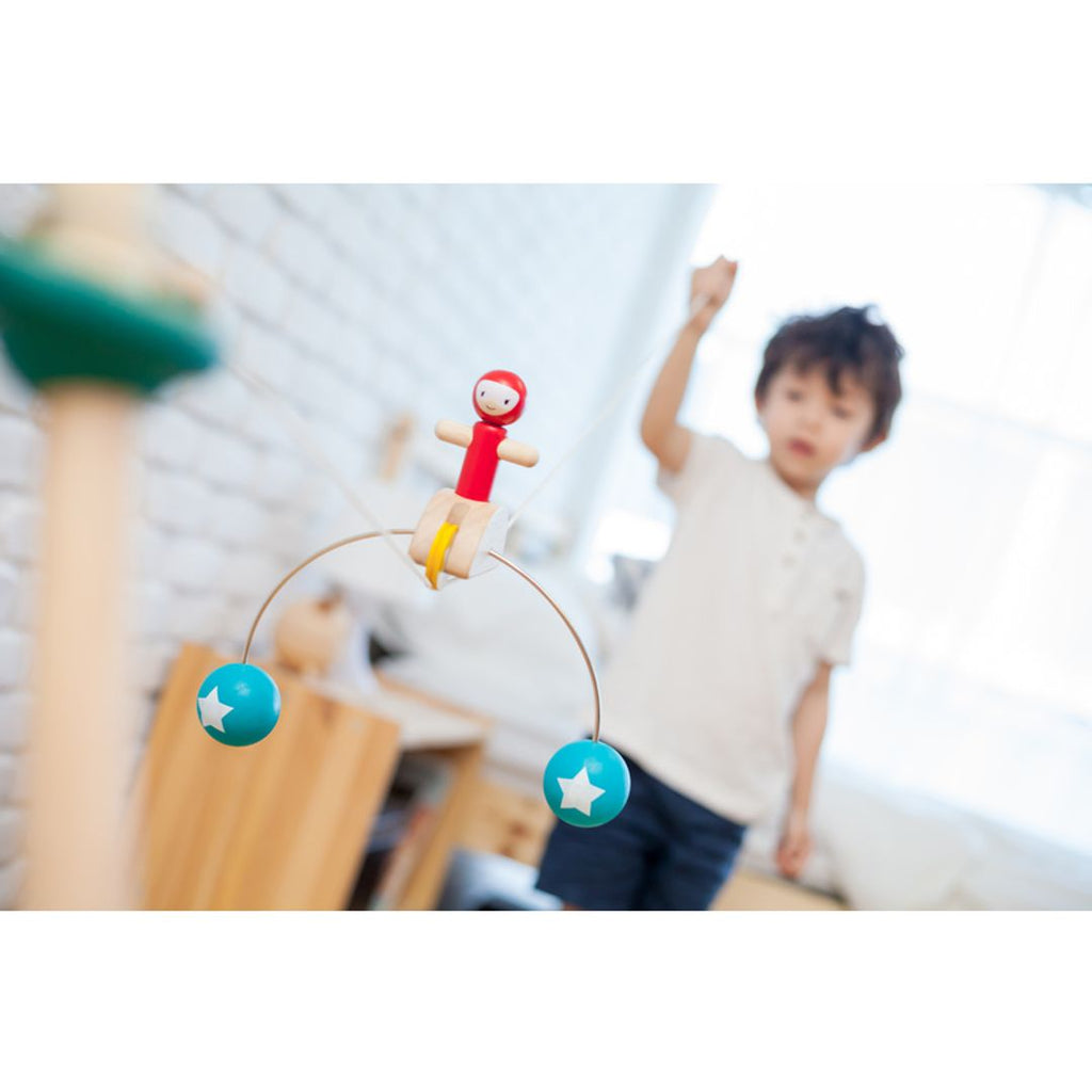 Kid playing PlanToys Riding Acrobat