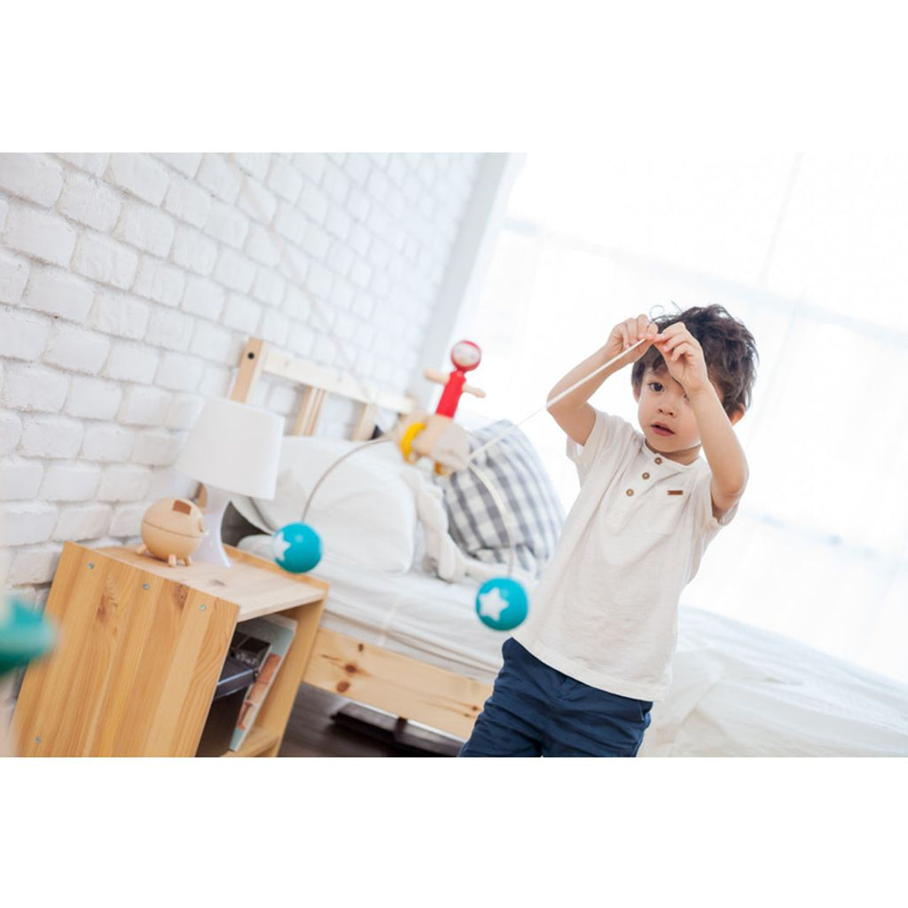 Kid playing PlanToys Riding Acrobat