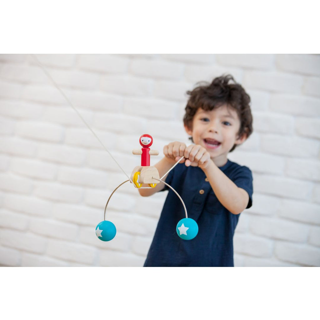 Kid playing PlanToys Riding Acrobat