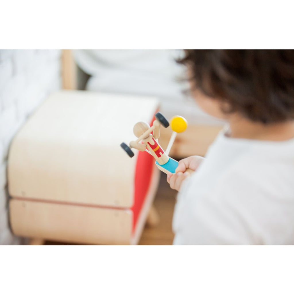 Kid playing PlanToys Weightlifting Acrobat