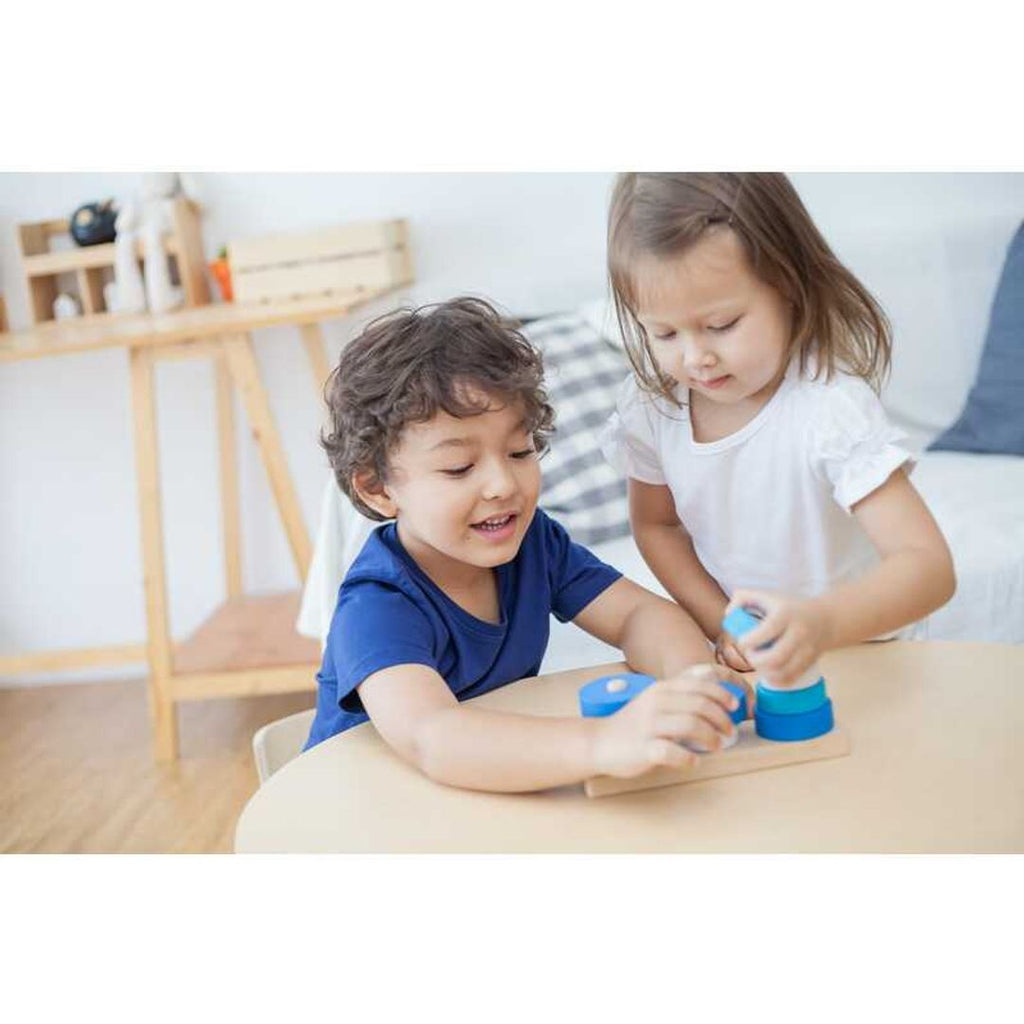 Kid playing PlanToys Trio Stacking