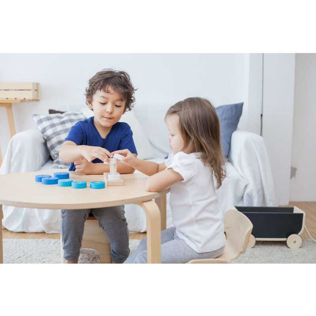 Kid playing PlanToys Trio Stacking