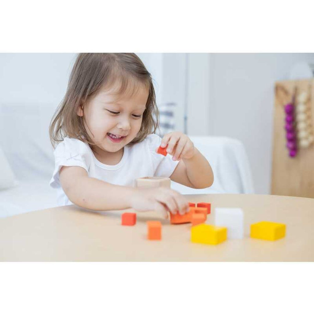 Kid playing PlanToys Fraction Cubes