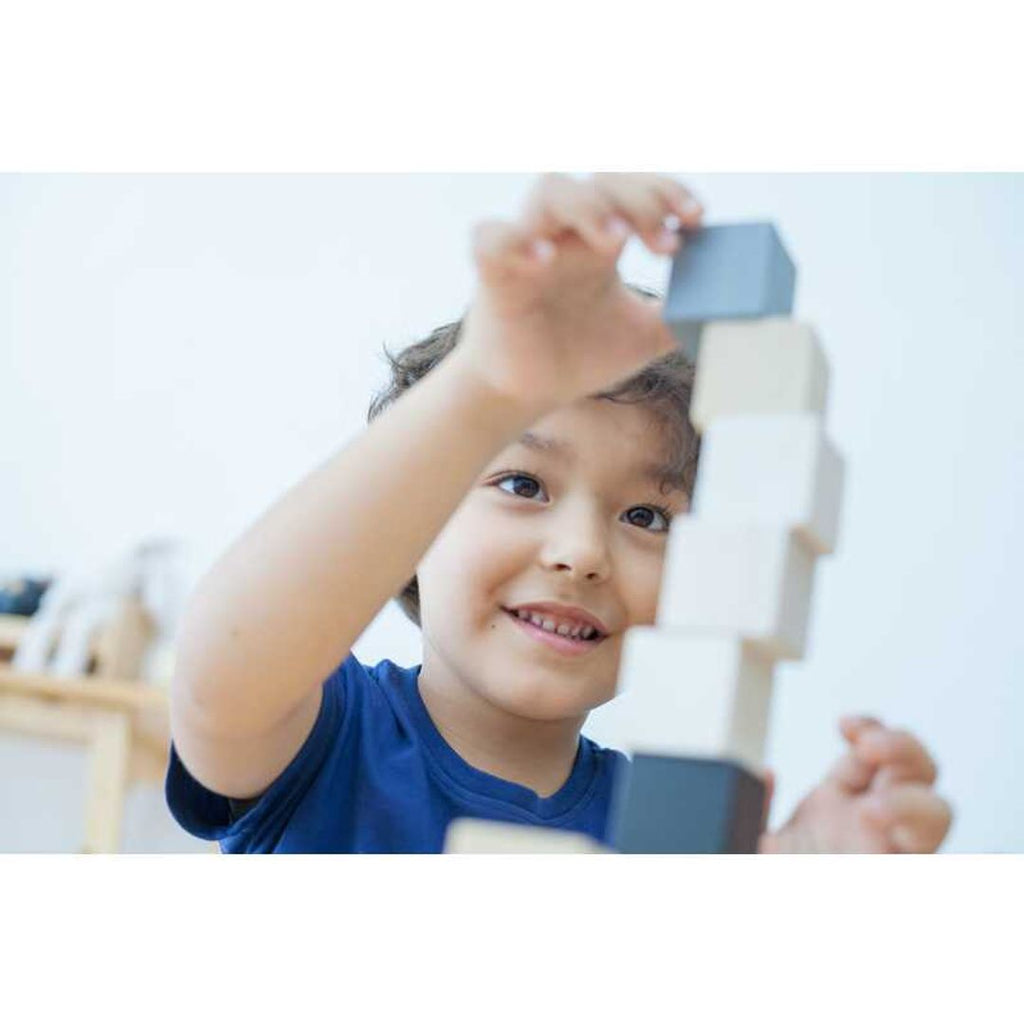 Kid playing PlanToys Cubes