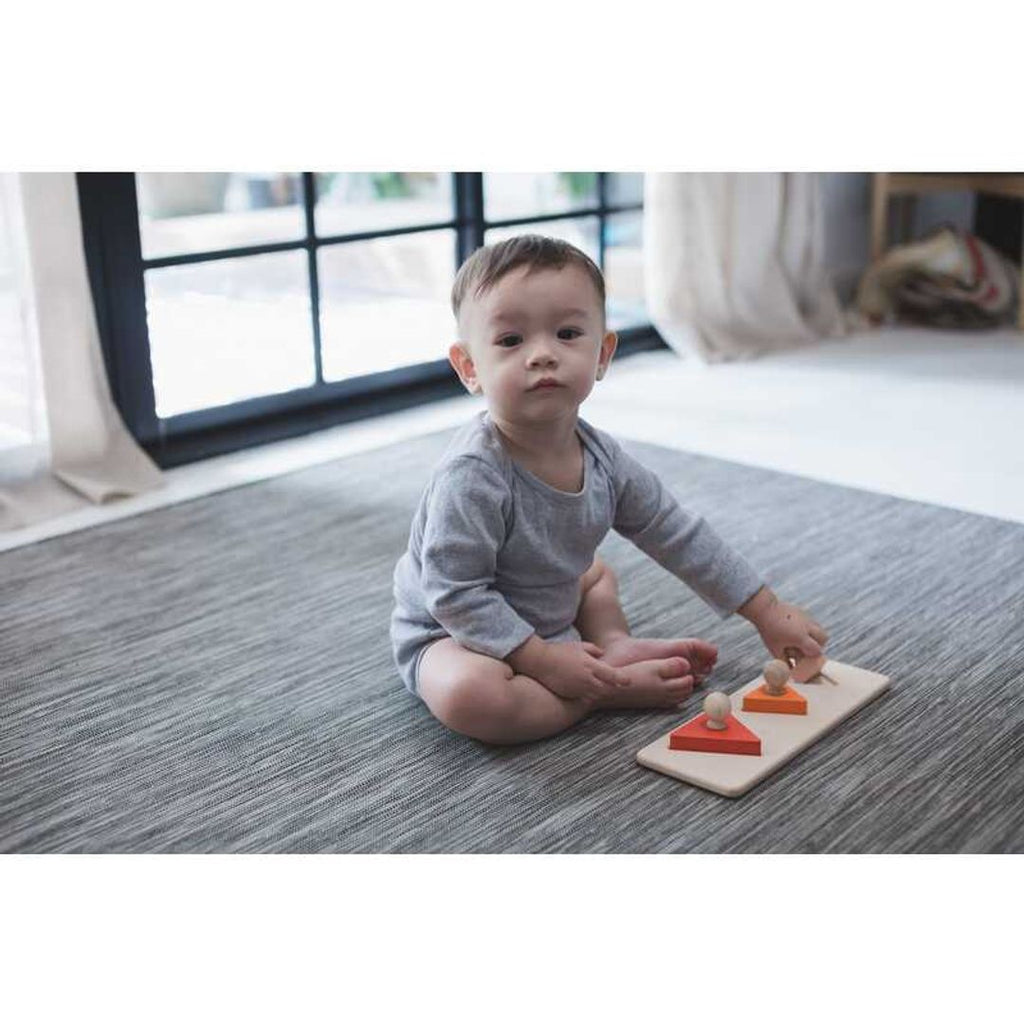 Kid playing PlanToys Triangle Matching Puzzle