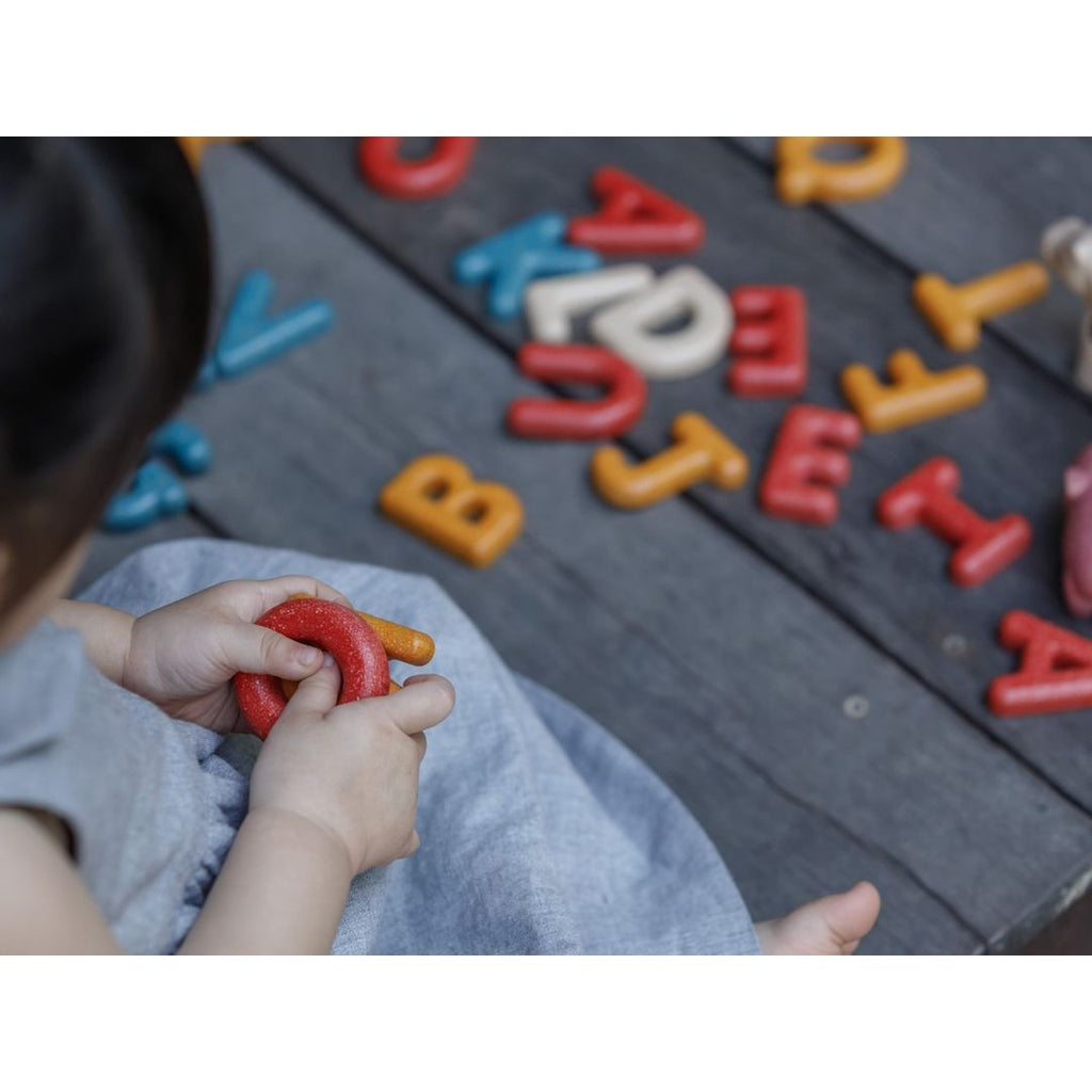 Kid playing PlanToys Upper Case Alphabet