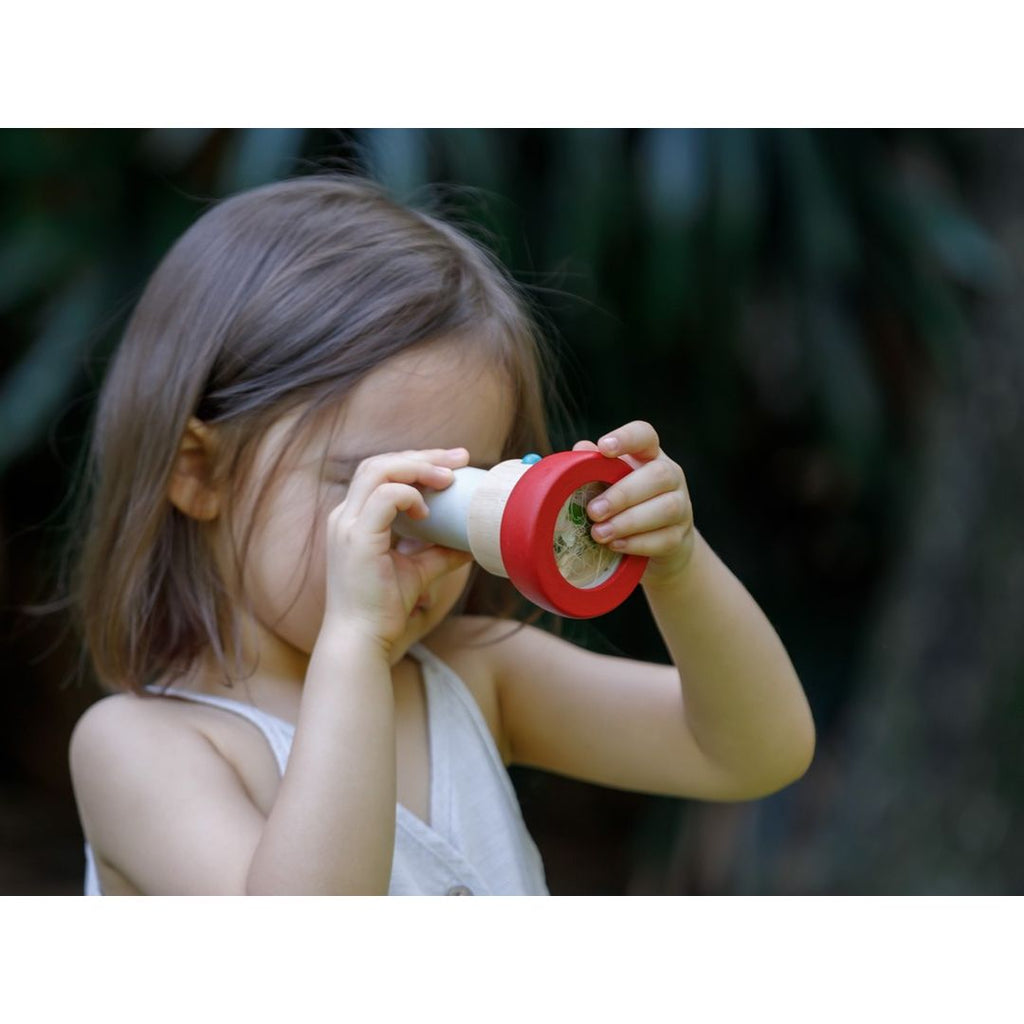 Kid playing PlanToys Kaleidoscope