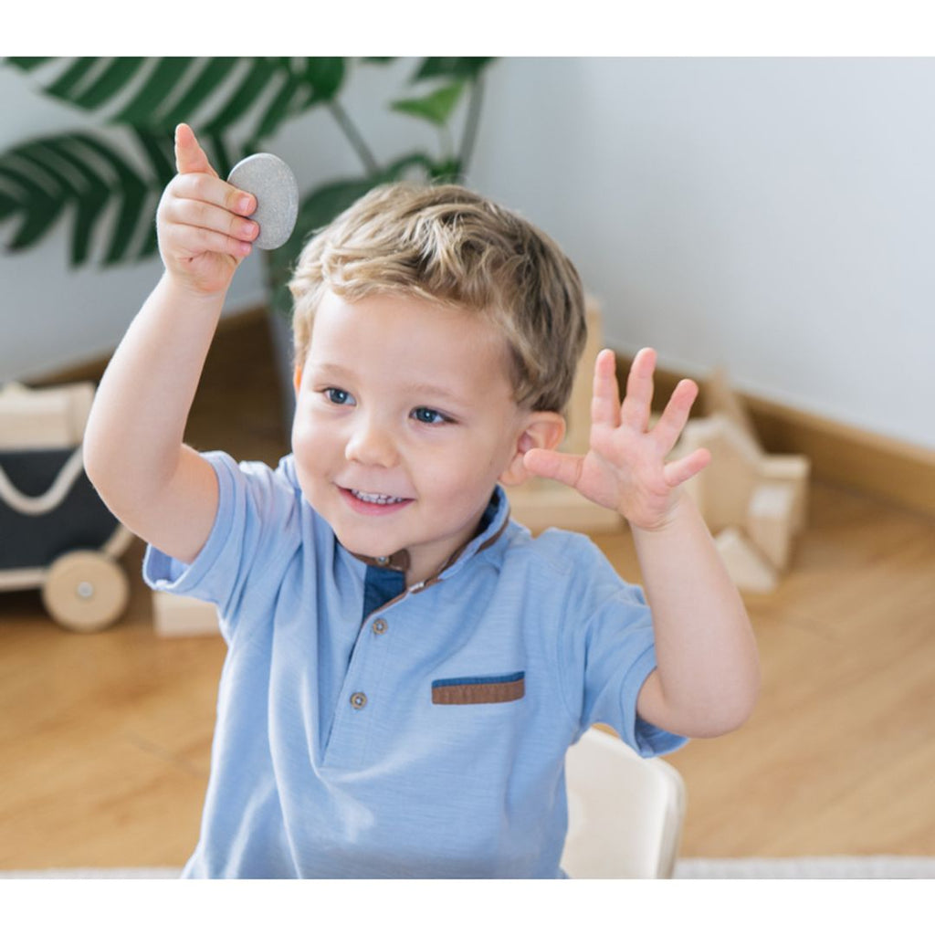 Kid playing PlanToys Tactile Stone