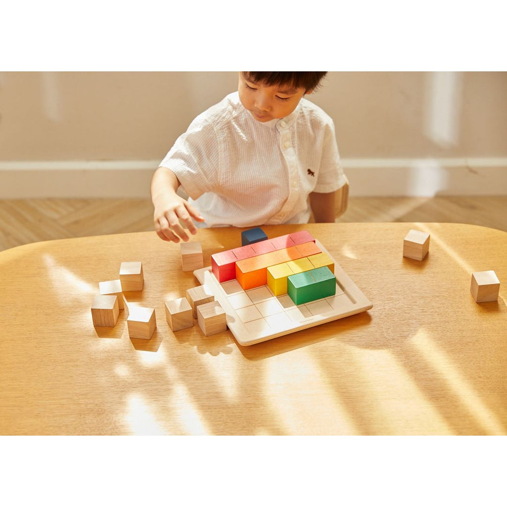 Kid playing PlanToys Colored Counting Blocks - Unit Plus