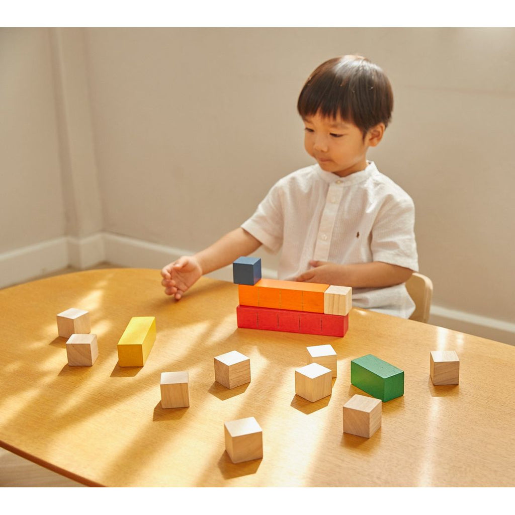 Kid playing PlanToys Colored Counting Blocks - Unit Plus