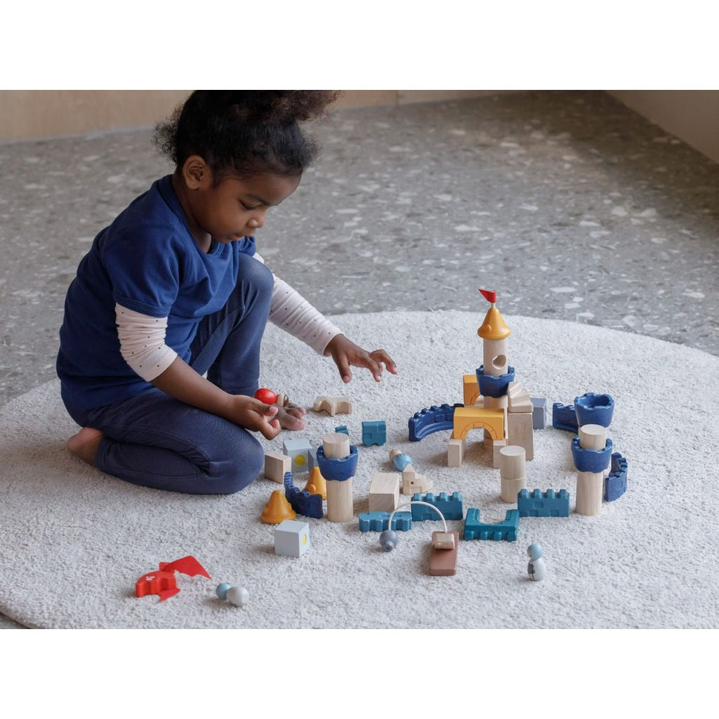 Kid playing PlanToys Castle Blocks - Orchard Series