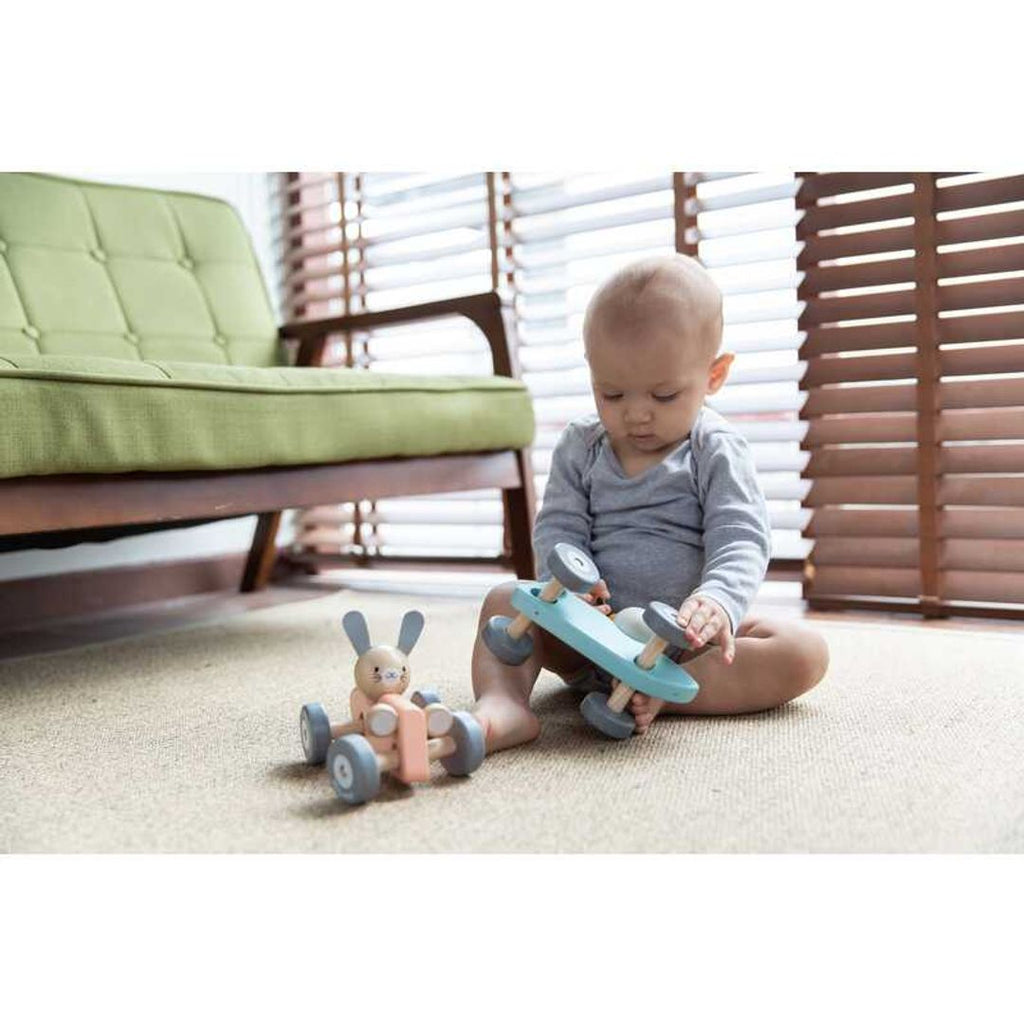 Kid playing PlanToys Chicken Racing Car