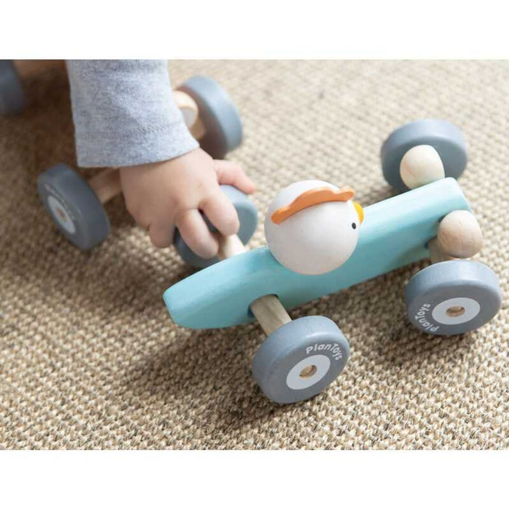 Kid playing PlanToys Chicken Racing Car