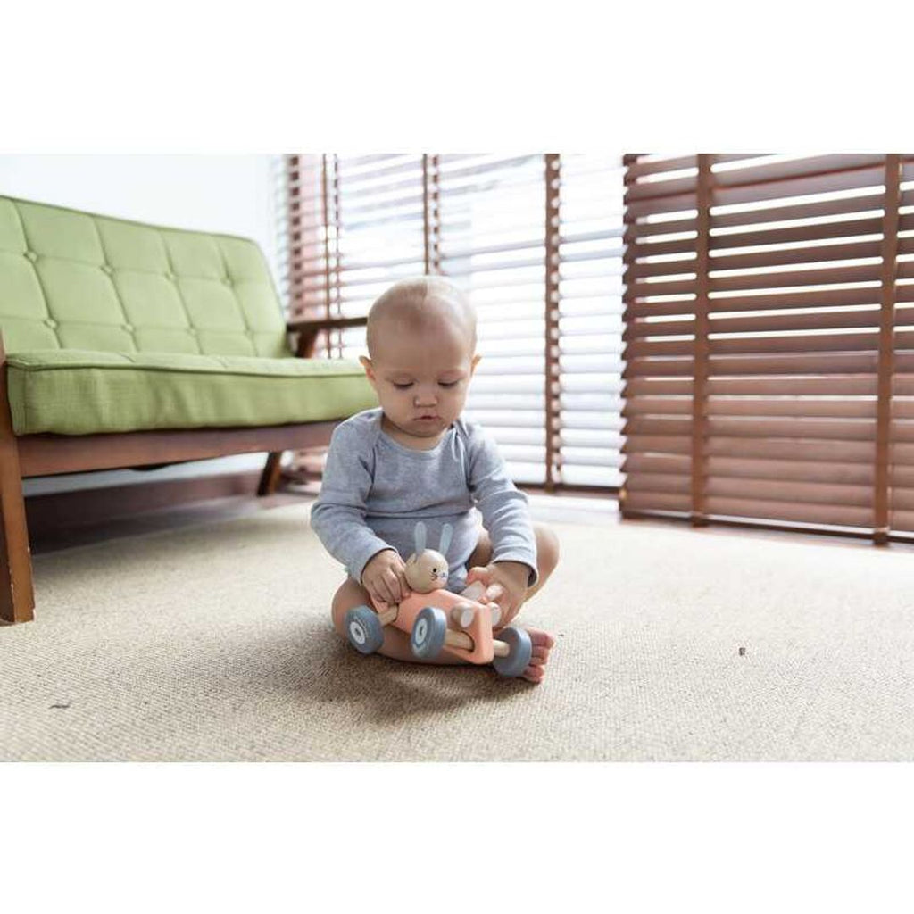 Kid playing PlanToys Bunny Racing Car