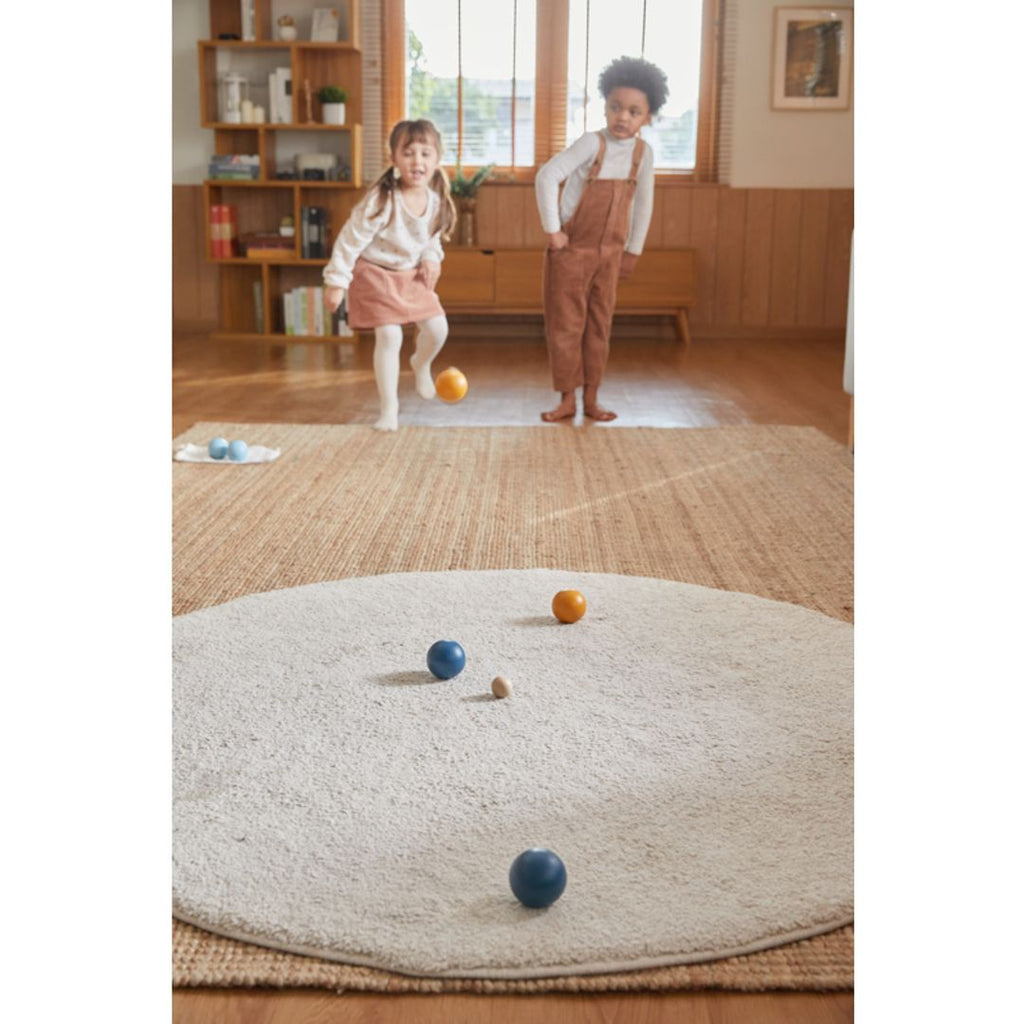 Kid playing PlanToys Pétanque