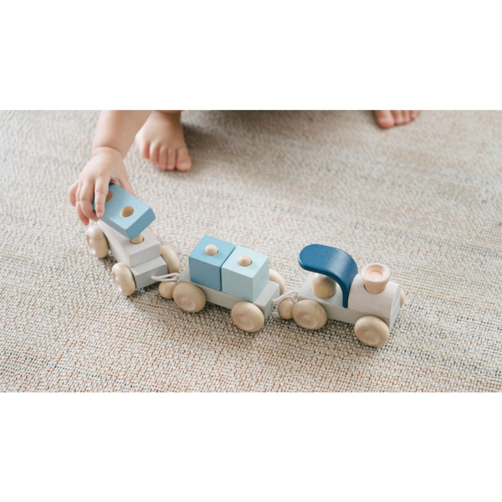 Kid playing PlanToys Stacking Train Trio - Orchard