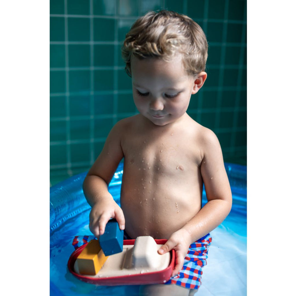 Kid playing PlanToys Cargo Ship