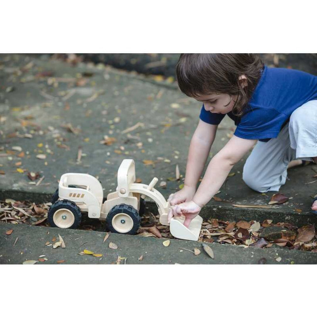 Kid playing PlanToys Bulldozer