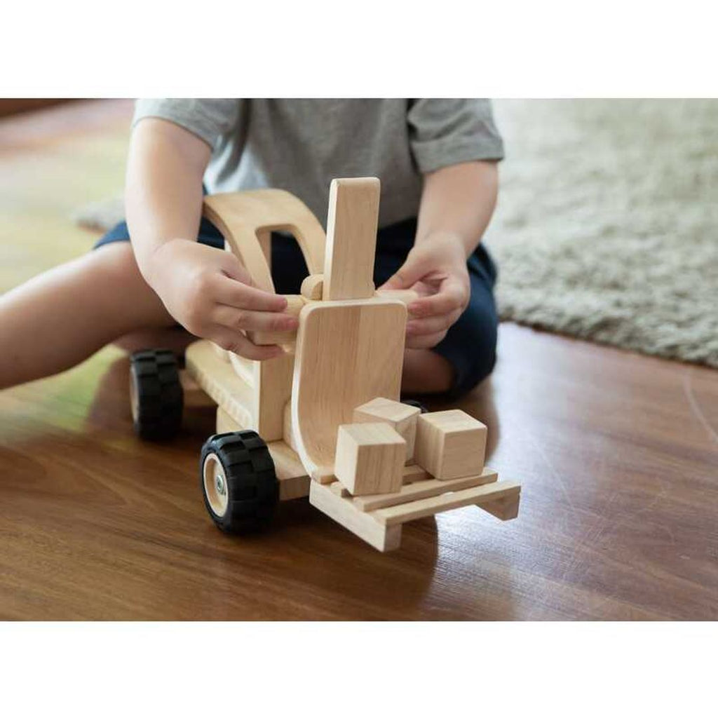 Kid playing PlanToys Forklift