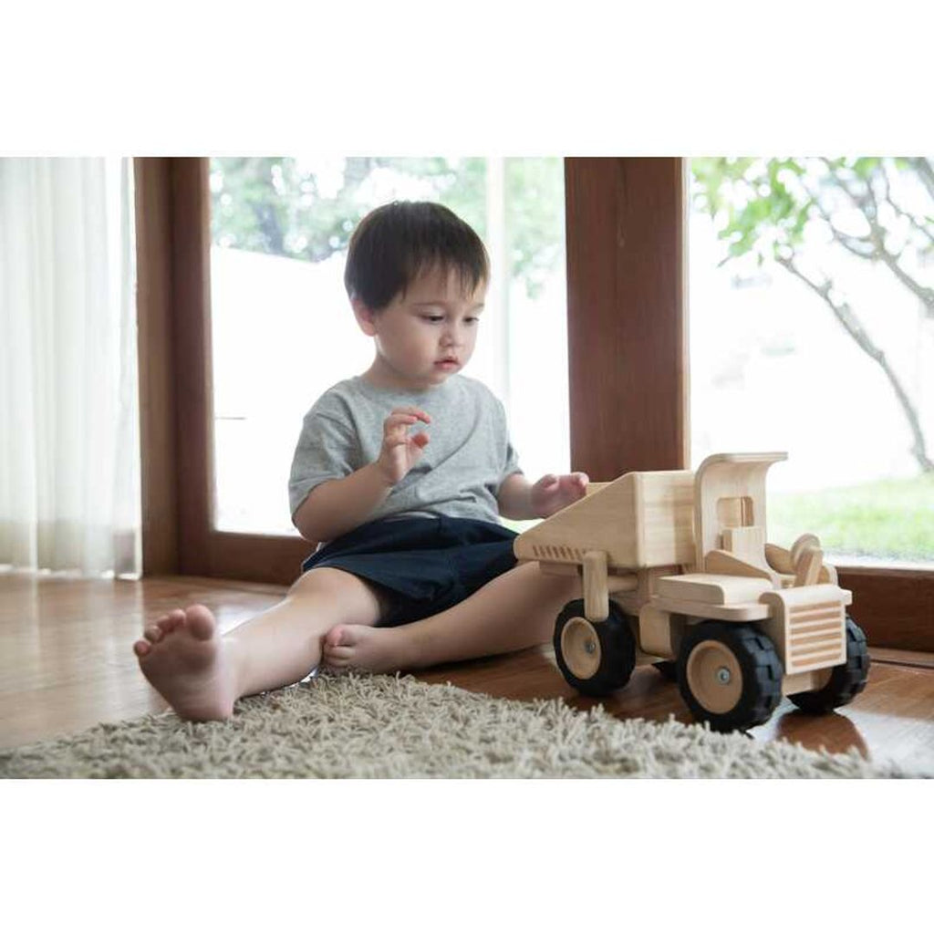 Kid playing PlanToys Dump Truck