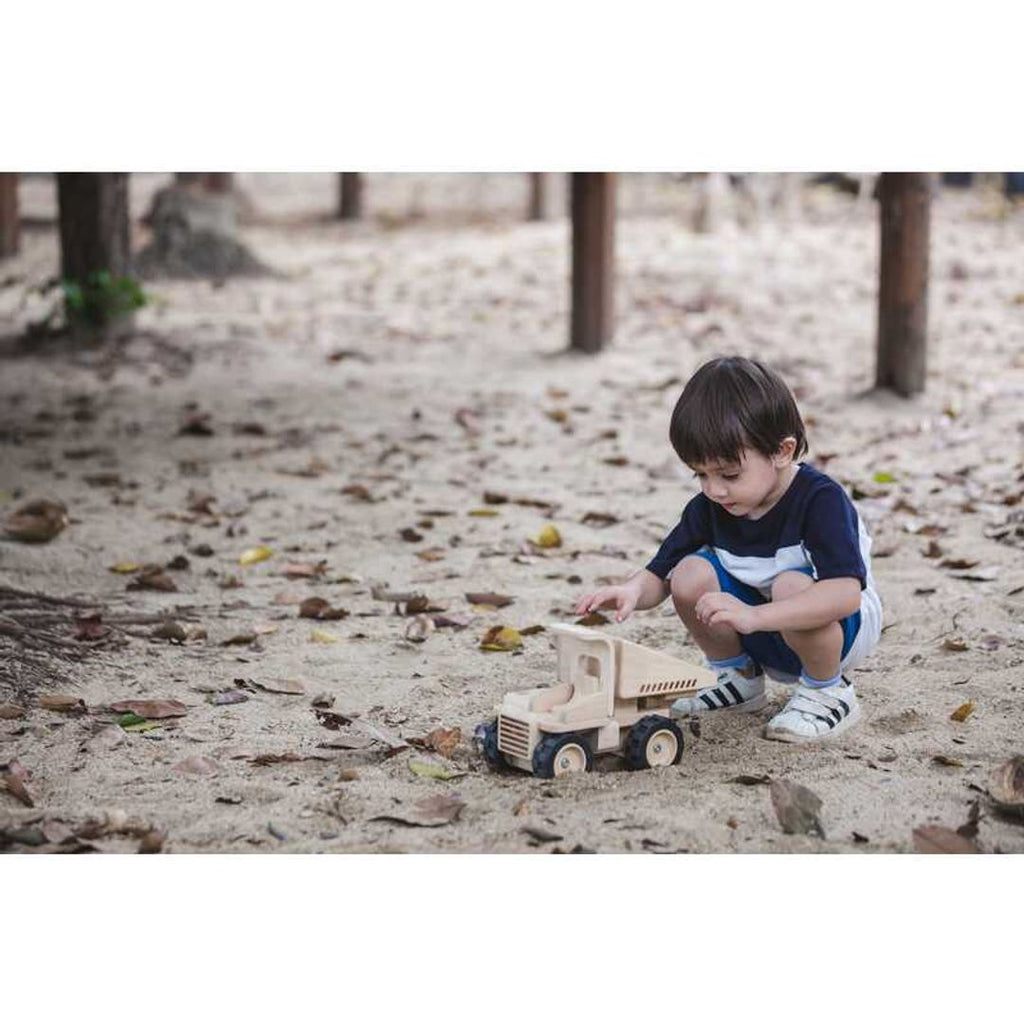 Kid playing PlanToys Dump Truck