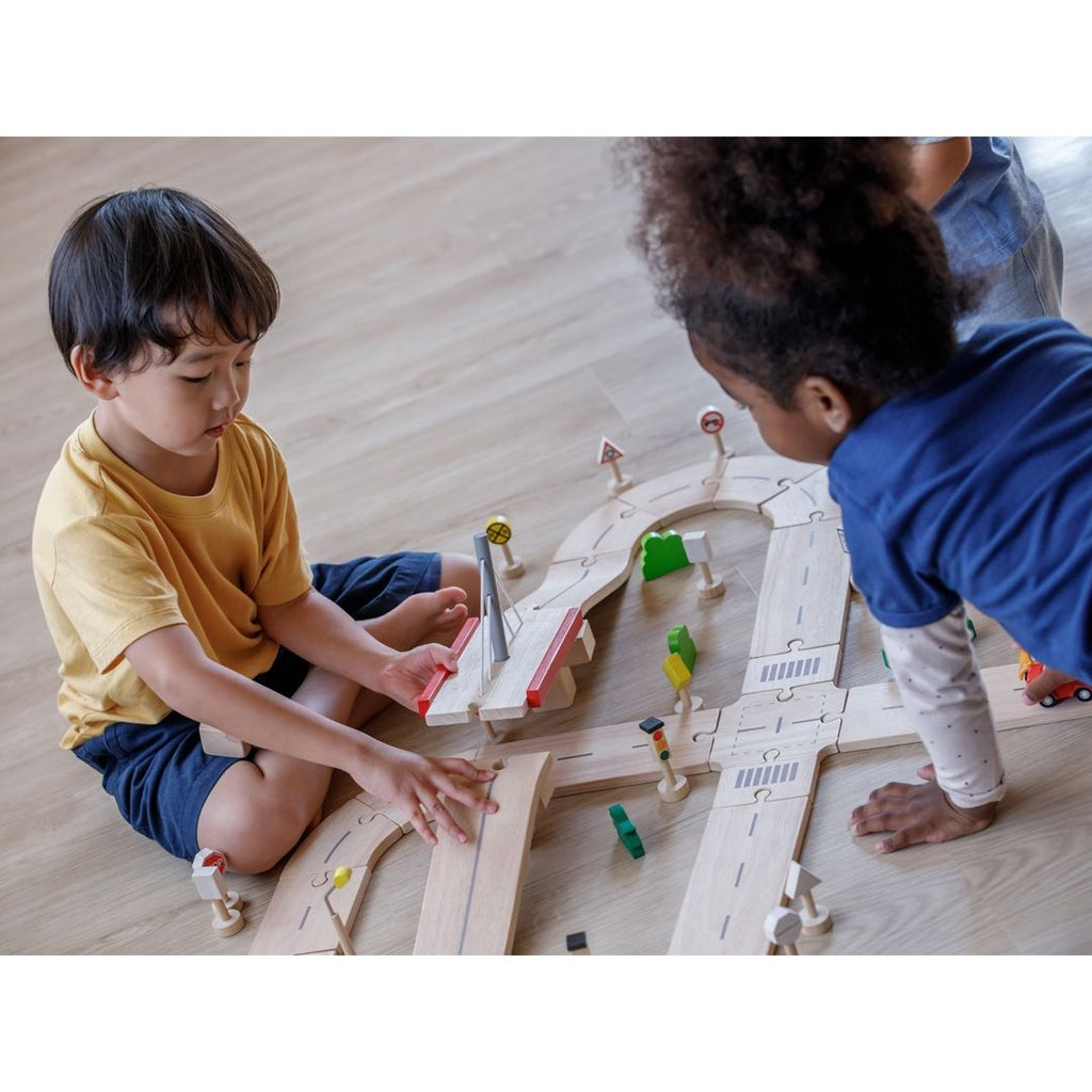 Kid playing PlanToys Road System